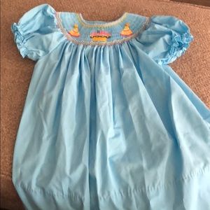 Knee length smocked dress with two candles